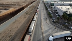 Aerial view of trucks queueing next to the border wall before crossing to the United States at Otay commercial port in Tijuana, Baja California state, Mexico, Jan. 22, 2025. 